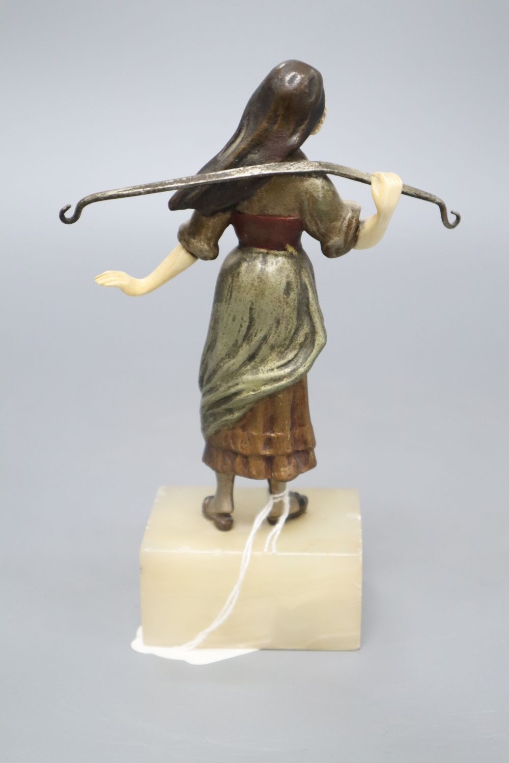 A 19th century cold painted bronze and ivory figure of a milkmaid, on an onyx base, overall height 17cm